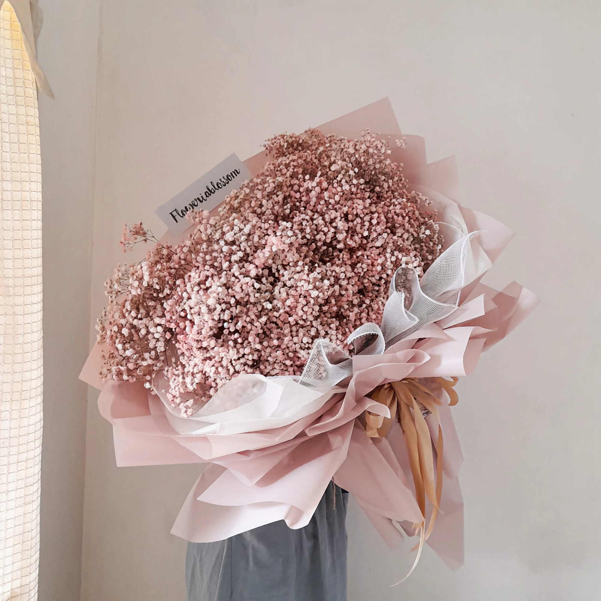 Florist carefully arranging a fresh flower bouquet